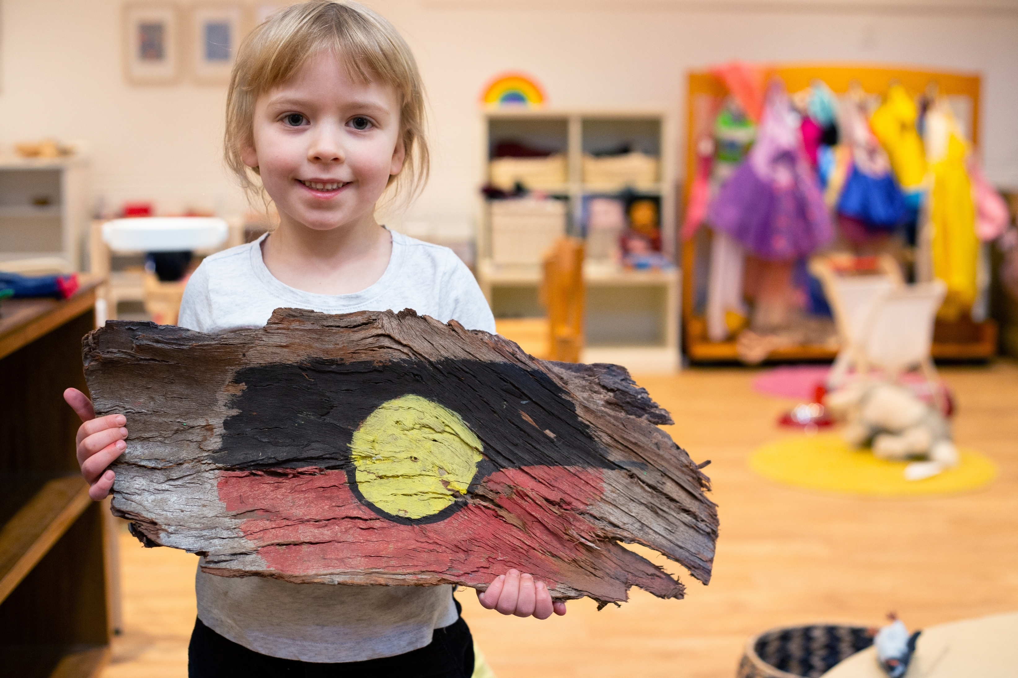 Little girl holding aboriginal flag